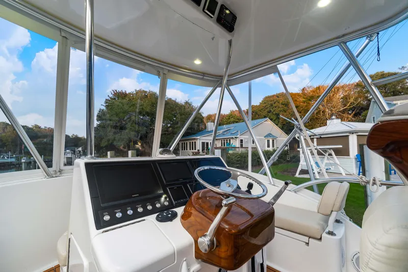 Fin Planner II Yacht Photos Pics 2021 Viking 38 Billfish helm with modern controls and scenic marina view.