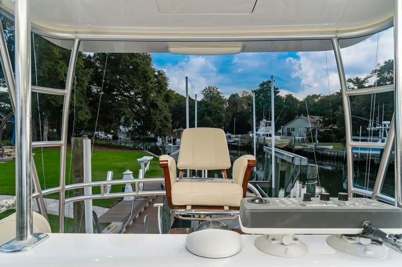 Fin Planner II Yacht Photos Pics Viking 38 Billfish 2021 helm view with chair and controls, dockside setting.