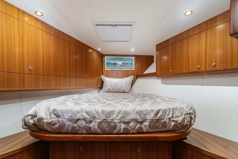 Fin Planner II Yacht Photos Pics Luxurious cabin interior of 2021 Viking 38 Billfish yacht with wood paneling and cozy bed.