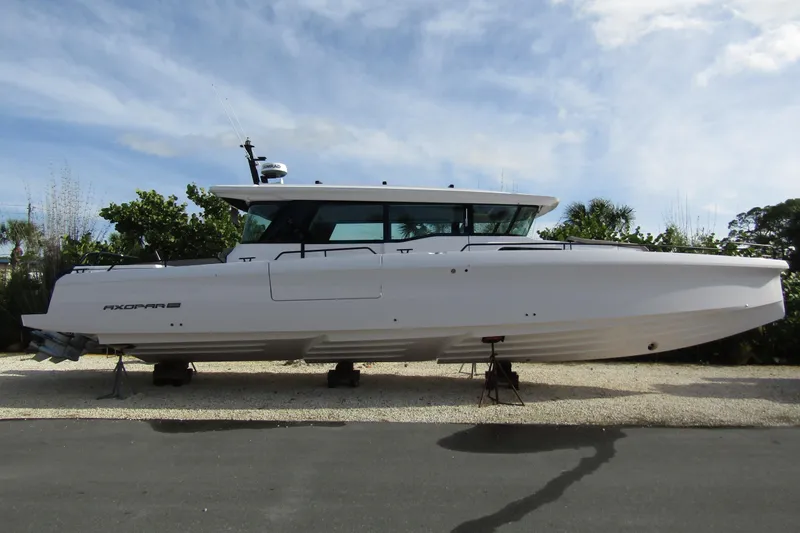  Yacht Photos Pics 2024 Axopar 45 XC Cross Cabin BRABUS Trim boat on display outdoors.