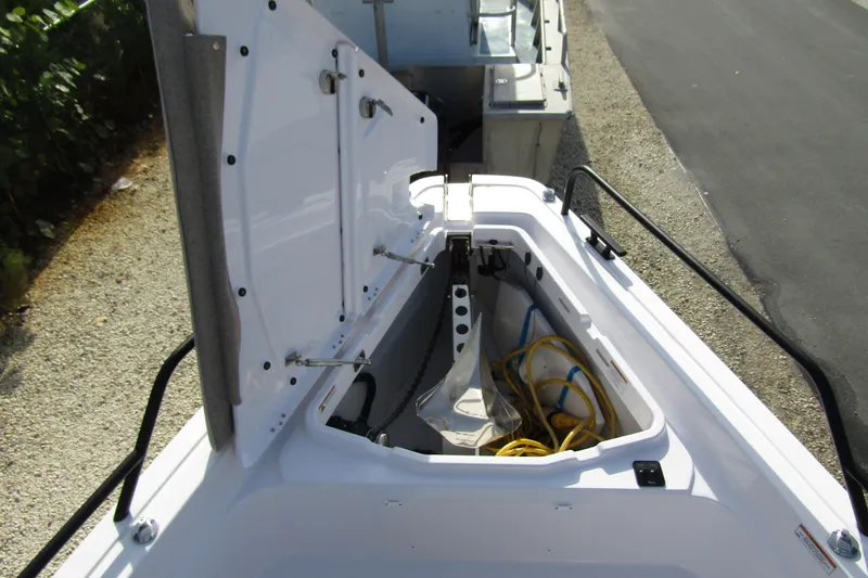  Yacht Photos Pics 2024 Axopar 45 XC Cross Cabin BRABUS Trim storage compartment with open hatch.