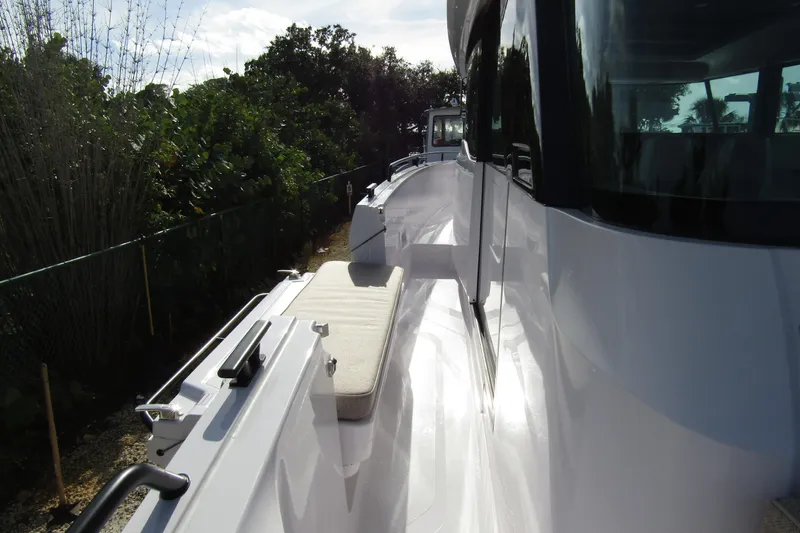  Yacht Photos Pics 2024 Axopar 45 XC Cross Cabin BRABUS Trim, side view with sleek design and seating.