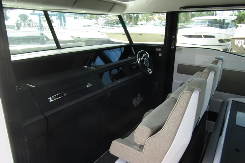  Yacht Photos Pics 2024 Axopar 45 XC Cross Cabin BRABUS Trim interior with modern steering and seating.