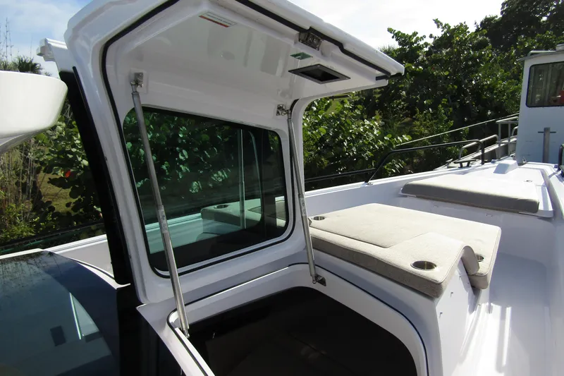  Yacht Photos Pics 2024 Axopar 45 XC Cross Cabin BRABUS Trim with open hatch and cushioned seating.