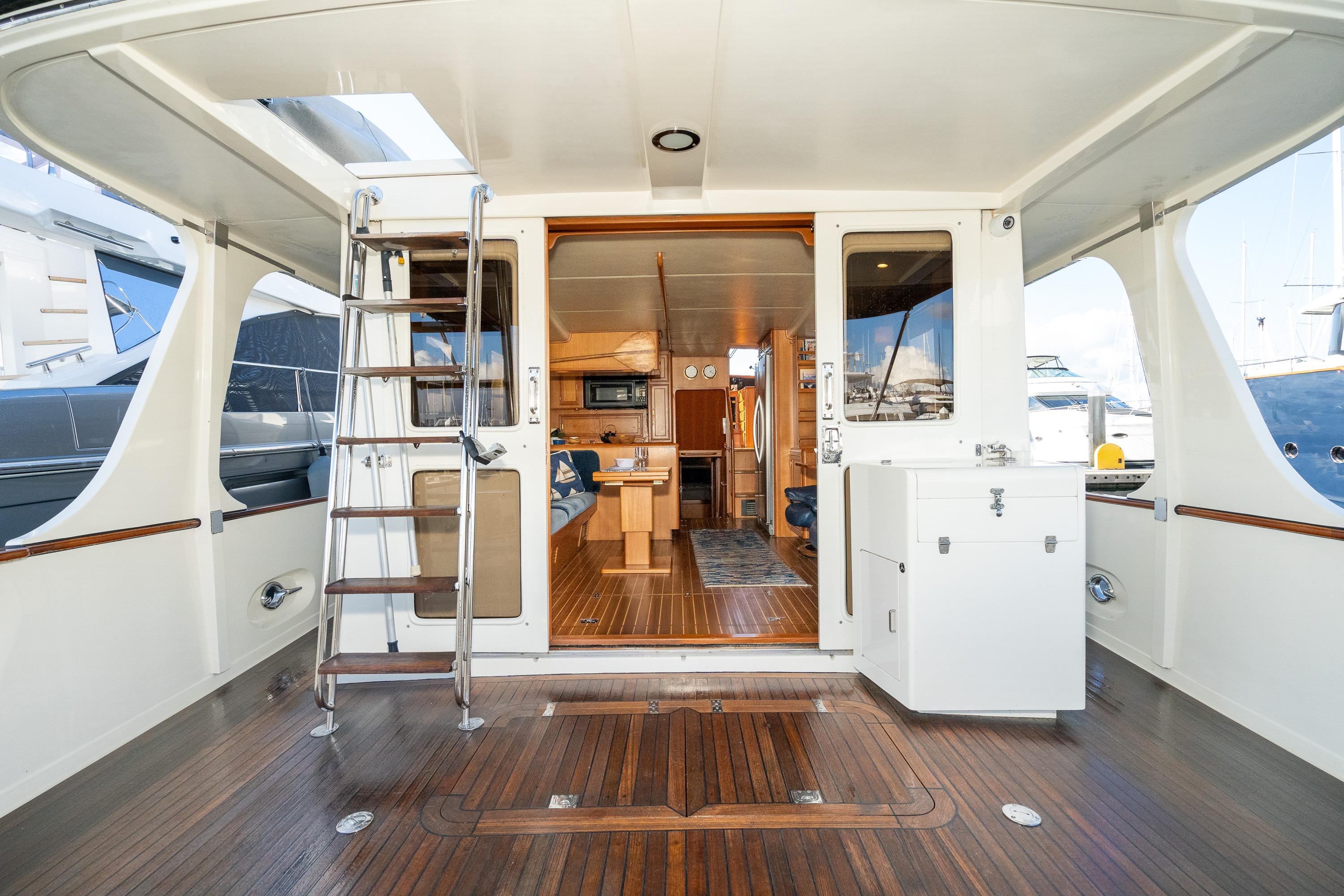 2001 Fleming 55 Pilothouse yacht interior with wooden flooring and modern amenities.