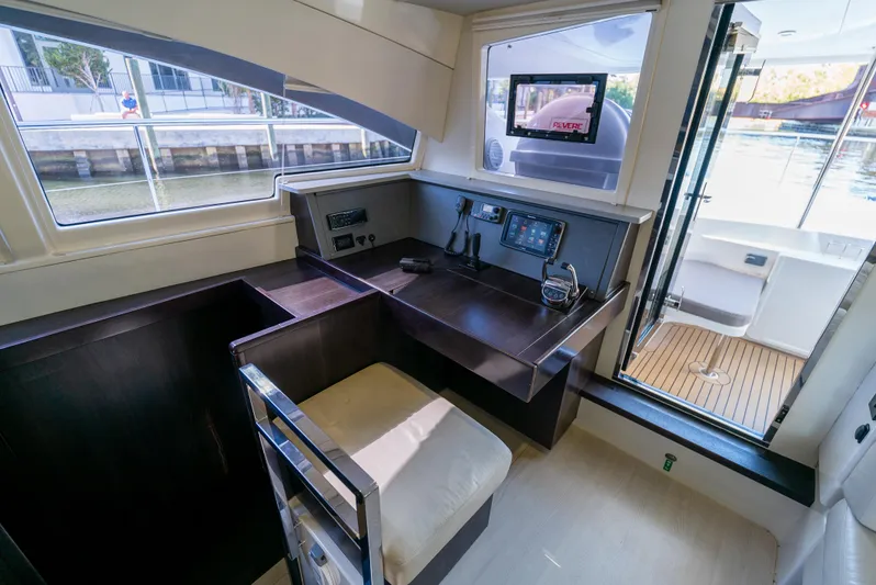  Yacht Photos Pics Interior of 2014 Leopard 51 Powercat with navigation station and outdoor view.