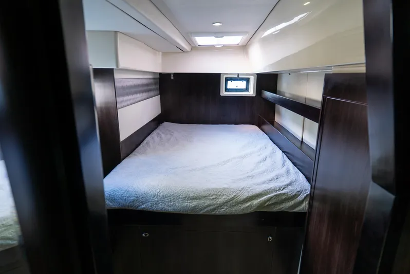  Yacht Photos Pics Cabin interior of 2014 Leopard 51 Powercat with bed and small window.