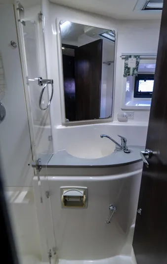  Yacht Photos Pics 2014 Leopard 51 Powercat bathroom with modern fixtures and mirror.
