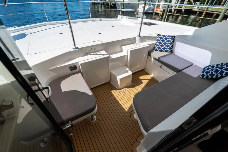  Yacht Photos Pics 2014 Leopard 51 Powercat deck with seating, cushions, and wooden flooring.