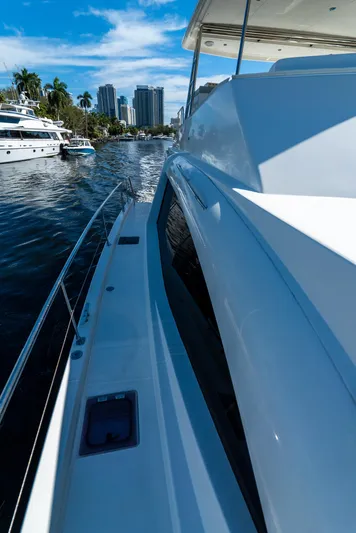  Yacht Photos Pics 2014 Leopard 51 Powercat yacht cruising on a sunny day, with city skyline in the background.