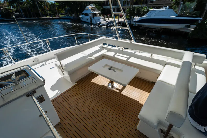  Yacht Photos Pics Spacious deck of 2014 Leopard 51 Powercat with seating and table, docked by the water.