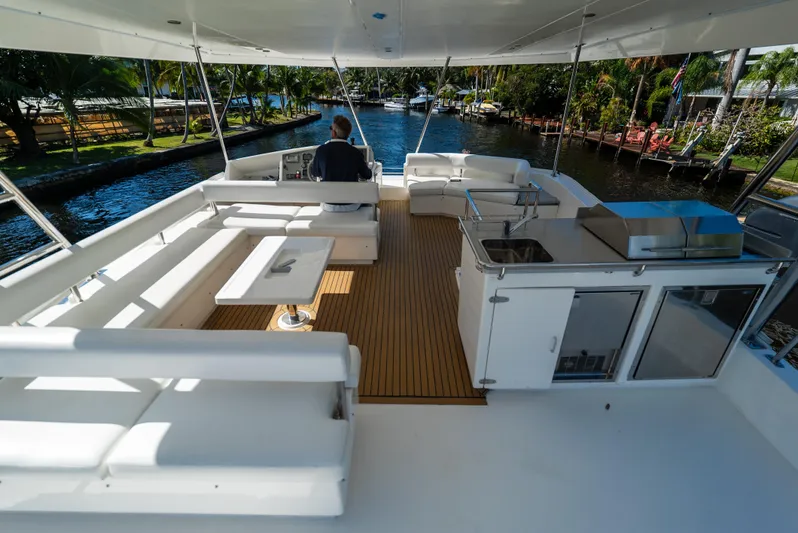 Yacht Photos Pics 2014 Leopard 51 Powercat yacht deck with seating, table, and outdoor kitchen.