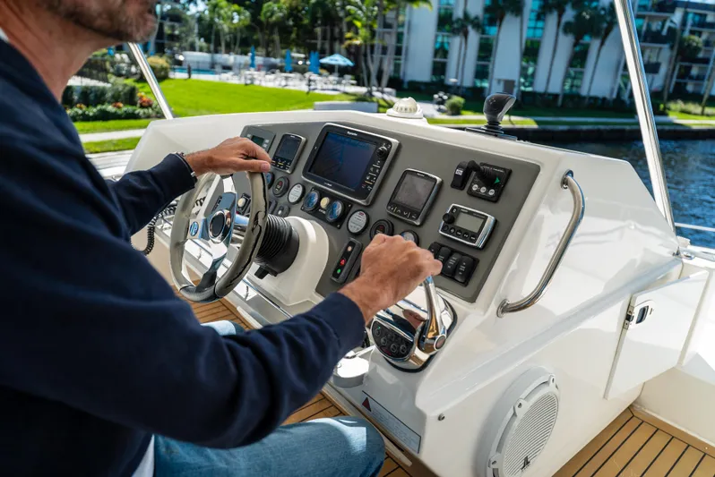  Yacht Photos Pics Person operating 2014 Leopard 51 Powercat helm with navigation instruments.