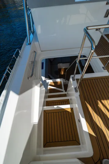  Yacht Photos Pics Stairway on 2014 Leopard 51 Powercat, featuring teak flooring and stainless steel railings.