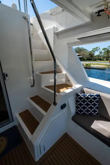  Yacht Photos Pics Staircase on 2014 Leopard 51 Powercat yacht with wooden steps and cushioned seating.