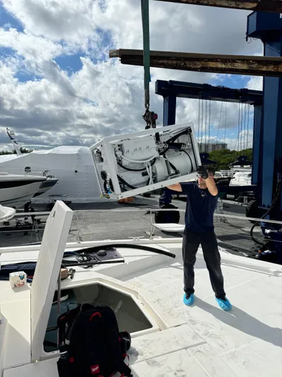  Yacht Photos Pics Person working on 2014 Leopard 51 Powercat yacht maintenance at a marina.