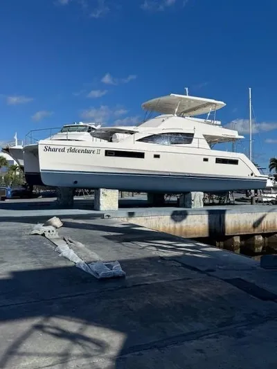  Yacht Photos Pics 2014 Leopard 51 Powercat yacht on dry dock under clear blue sky.