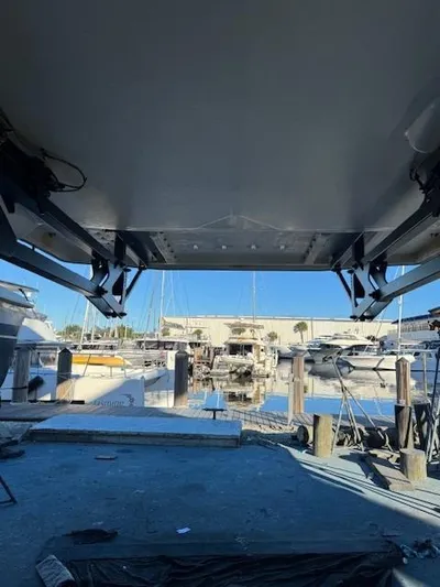  Yacht Photos Pics Leopard 51 Powercat 2014 at marina, view from underneath, surrounded by boats and clear sky.