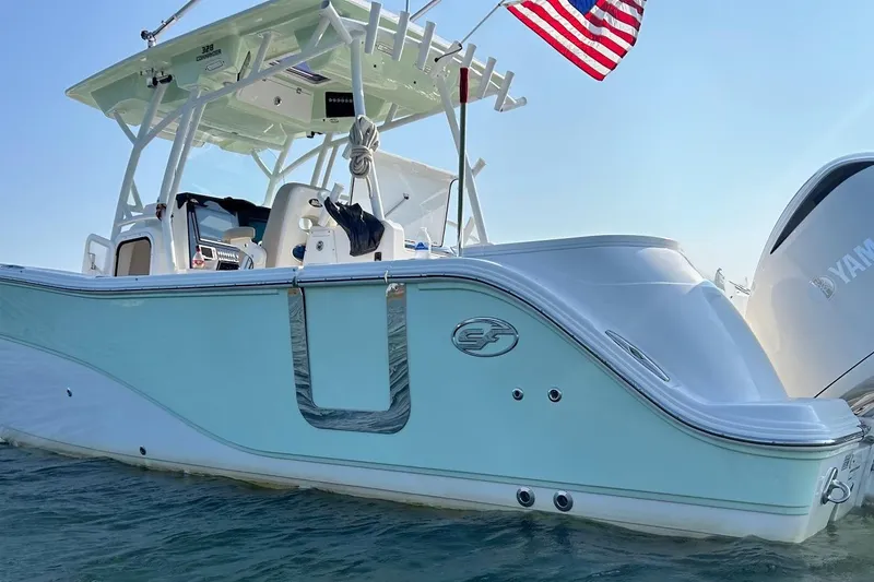  Yacht Photos Pics 2017 Sea Fox 328 Commander boat with American flag, docked on water.
