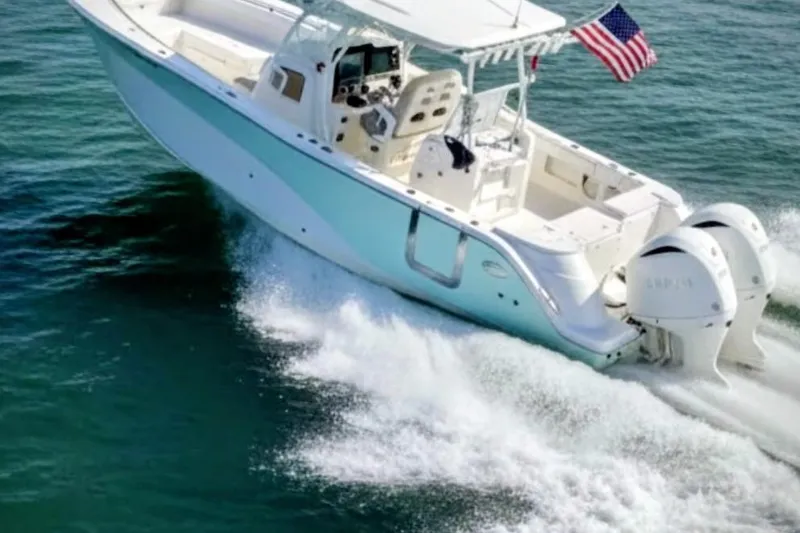  Yacht Photos Pics 2017 Sea Fox 328 Commander boat cruising on water with American flag.