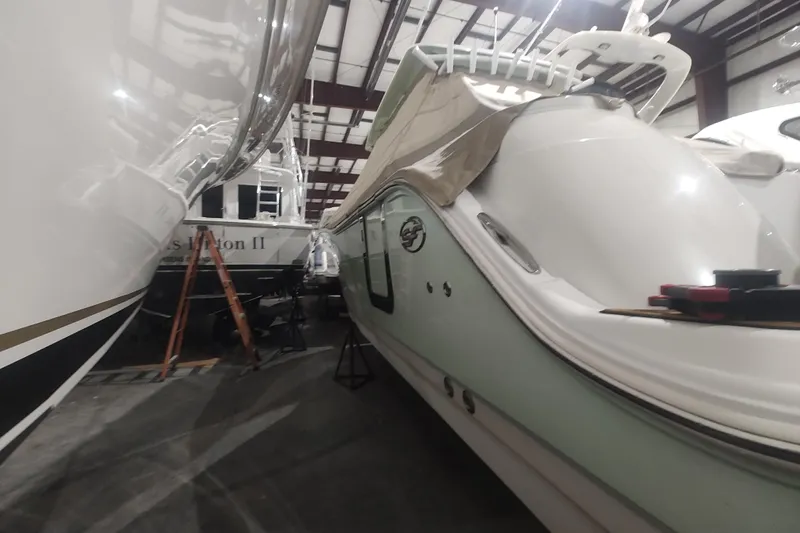  Yacht Photos Pics 2017 Sea Fox 328 Commander boat in storage, partially covered, with adjacent vessels.