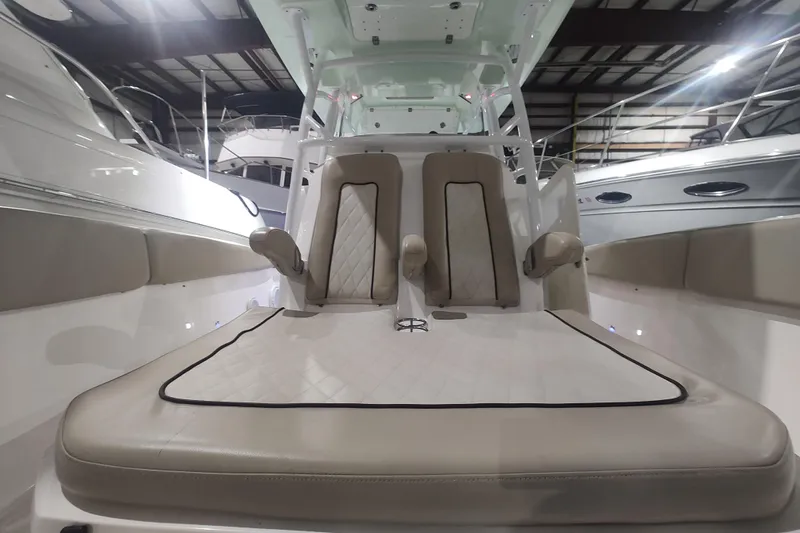  Yacht Photos Pics 2017 Sea Fox 328 Commander boat interior with cushioned seating in a showroom.