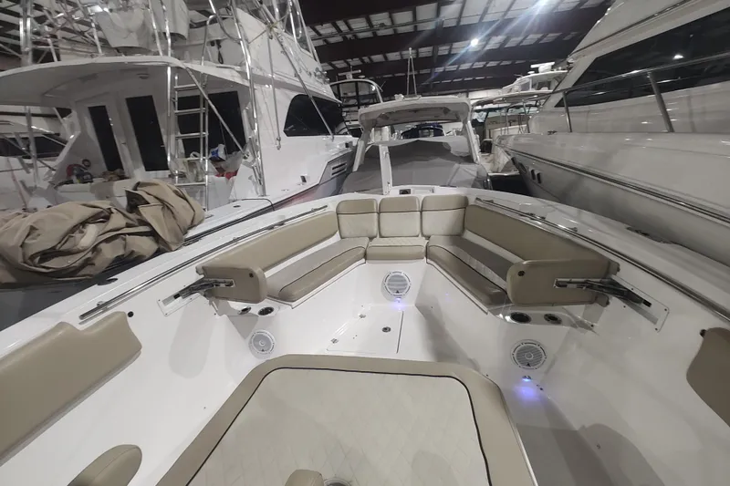  Yacht Photos Pics 2017 Sea Fox 328 Commander boat interior with beige seating in a marina.