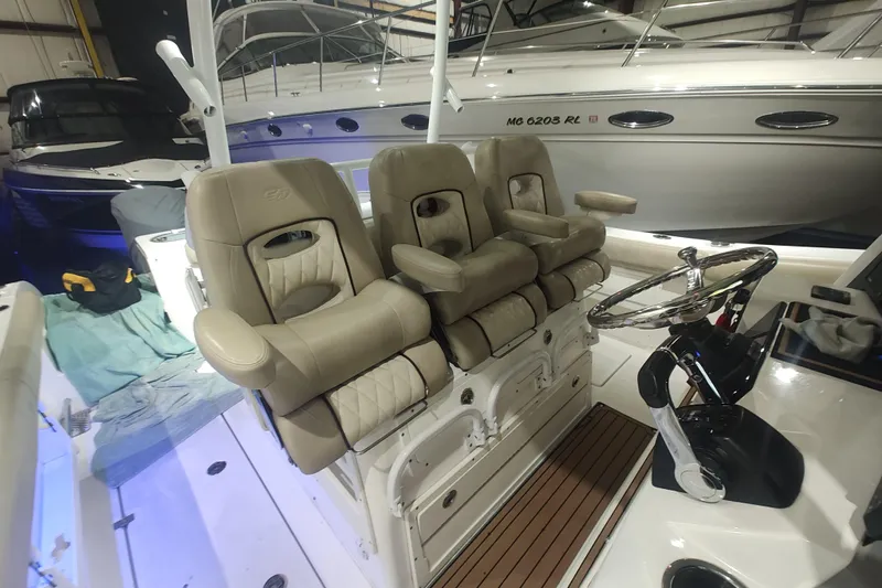 Yacht Photos Pics 2017 Sea Fox 328 Commander boat interior with plush seating and steering wheel.