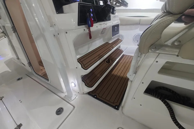  Yacht Photos Pics 2017 Sea Fox 328 Commander interior with teak steps and beige seating.