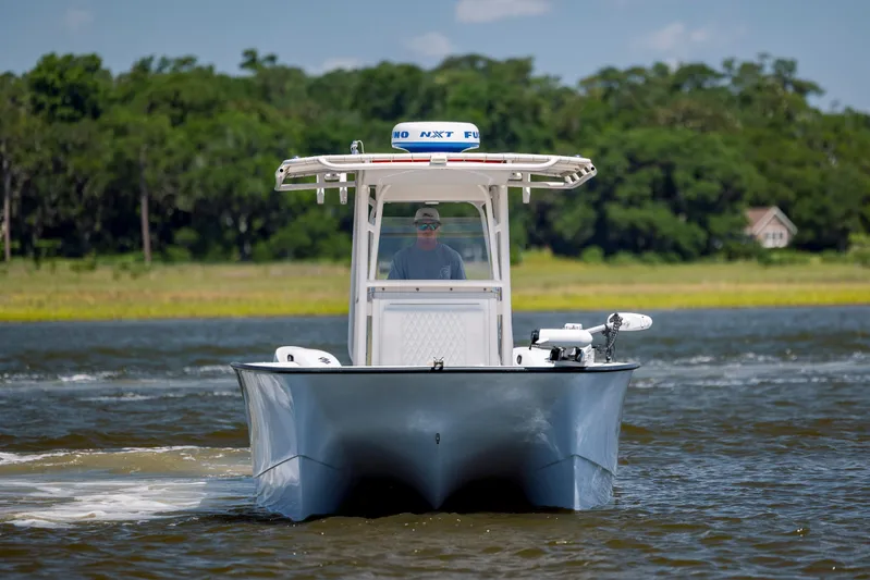  Yacht Photos Pics Calcutta 263 boat cruising on a river, 2023 model, with lush greenery in the background.