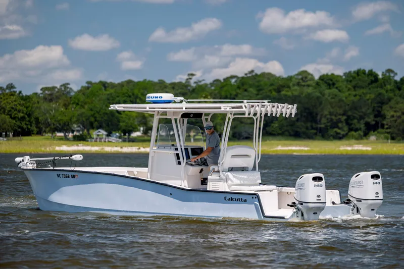  Yacht Photos Pics 2023 Calcutta 263 boat cruising on a lake with dual Suzuki engines.