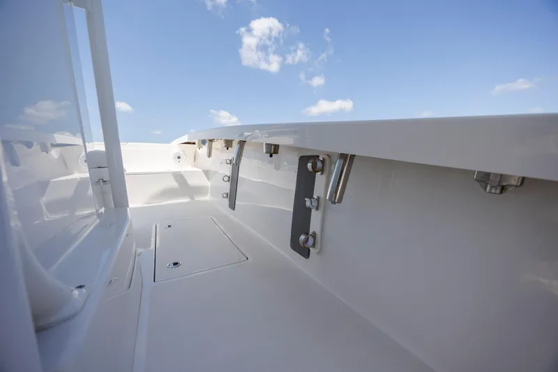  Yacht Photos Pics 2023 Calcutta 263 boat interior with sleek white finish and clear blue sky.