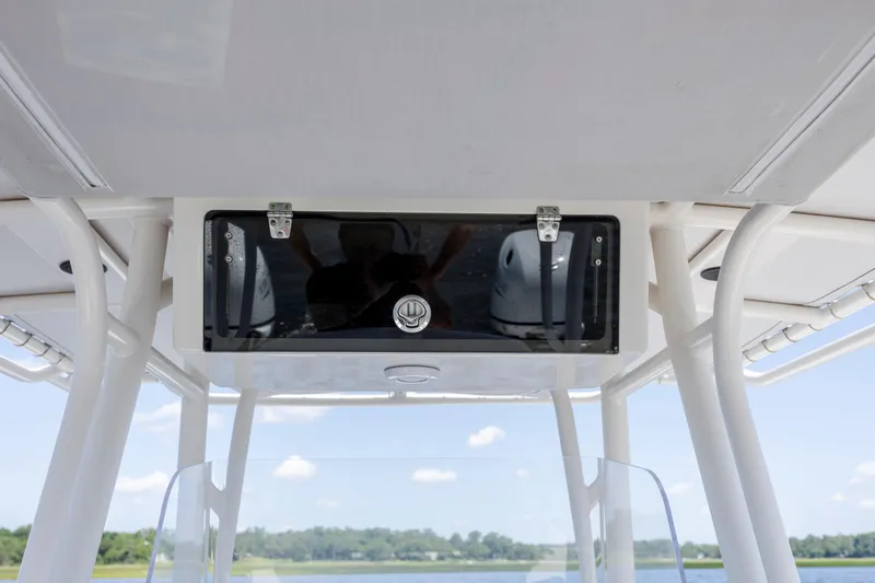  Yacht Photos Pics Calcutta 263 boat console with storage compartment, 2023 model, under clear blue sky.