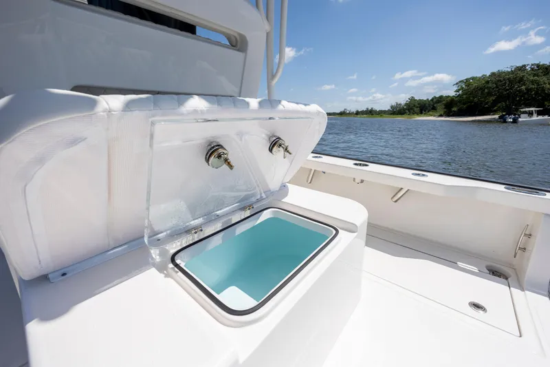  Yacht Photos Pics Open storage compartment on Calcutta 263 boat, 2023 model, with scenic water view.
