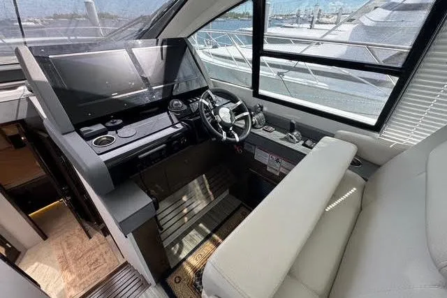  Yacht Photos Pics 2019 Cruisers Yachts 50 Cantius helm with modern controls and panoramic windows.