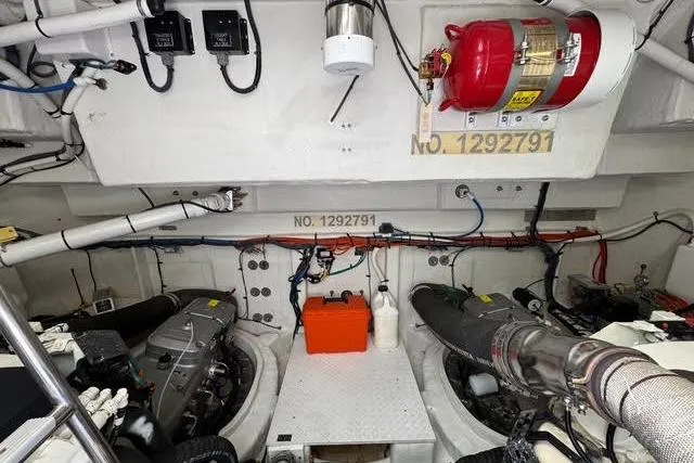  Yacht Photos Pics Engine room of 2019 Cruisers Yachts 50 Cantius with visible machinery and fire extinguisher.