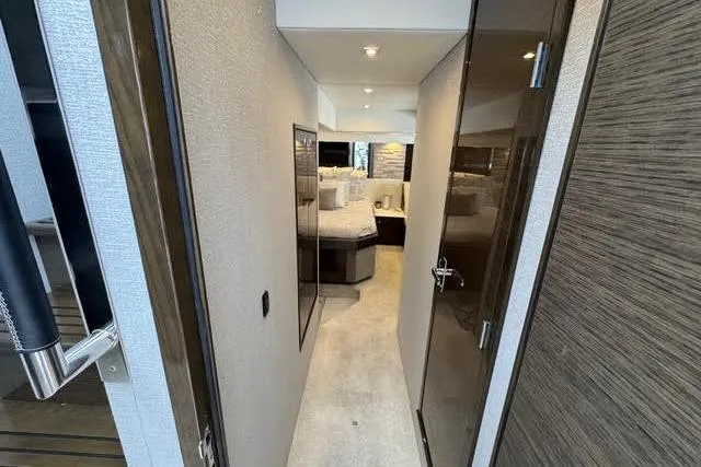  Yacht Photos Pics 2019 Cruisers Yachts 50 Cantius interior hallway leading to a luxurious bedroom.