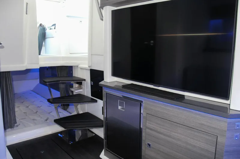  Yacht Photos Pics 2023 Aviara AV40 OB interior with TV, modern cabinetry, and sleek staircase.