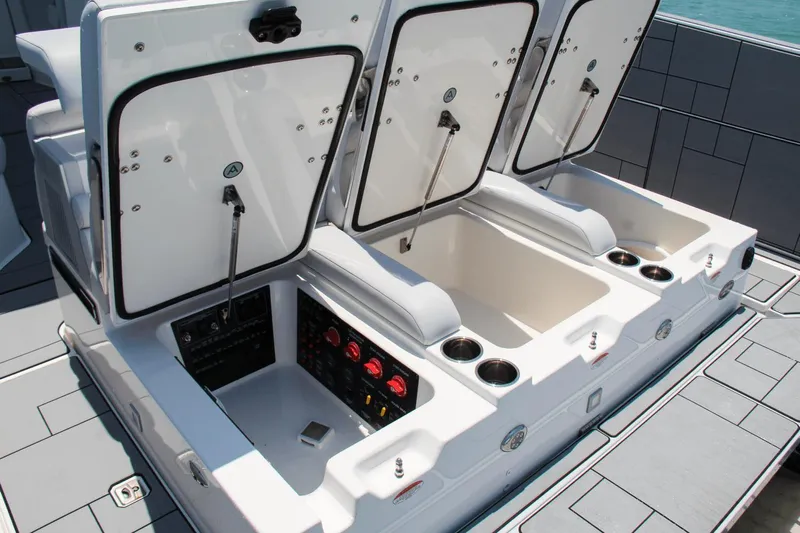  Yacht Photos Pics 2023 Aviara AV40 OB boat storage compartments with open lids and control panel.