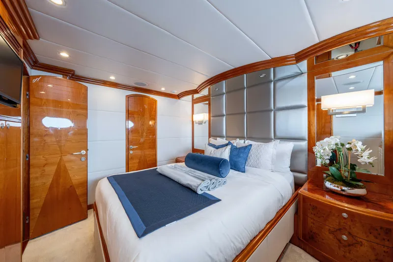 Yacht Photos Pics Luxurious bedroom interior on 2009 Hargrave Raised Pilothouse yacht, featuring elegant wood finishes.
