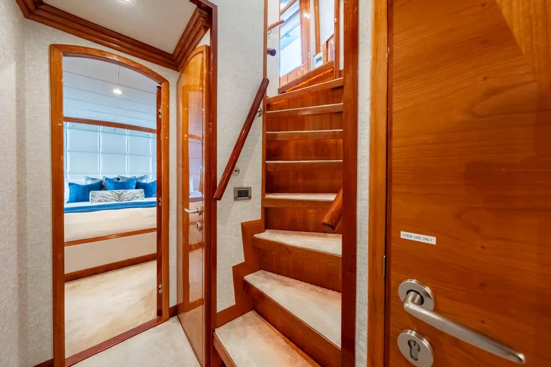  Yacht Photos Pics Luxurious interior of 2009 Hargrave Raised Pilothouse yacht with wooden stairs and bedroom.