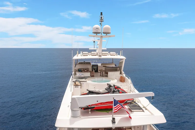  Yacht Photos Pics Luxury 2009 Hargrave Raised Pilothouse yacht on open sea, featuring spacious deck and American flag.