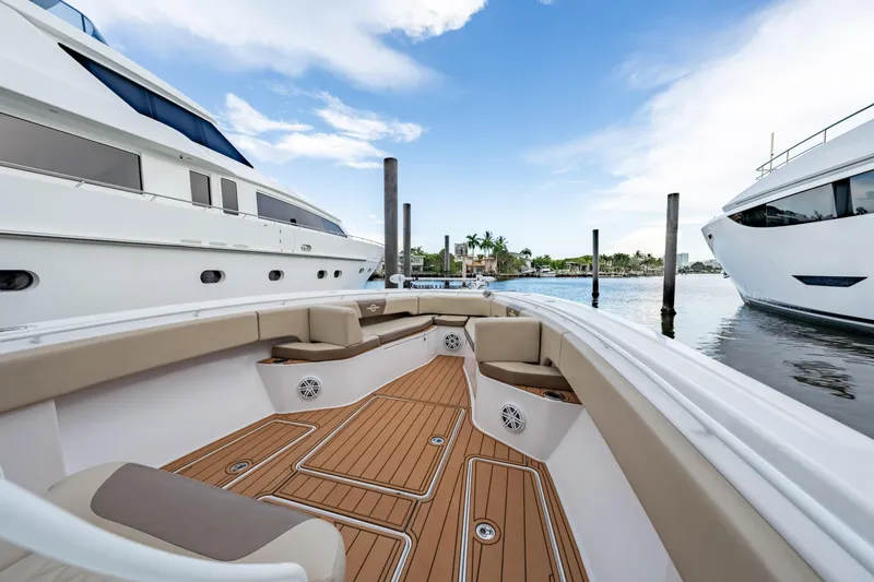  Yacht Photos Pics Luxurious 2009 Hargrave Raised Pilothouse yacht docked, featuring elegant deck seating and scenic waterfront view.