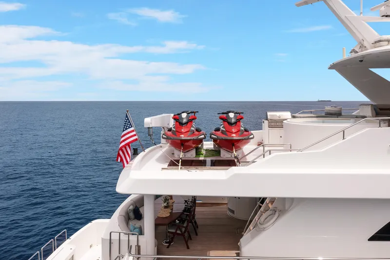  Yacht Photos Pics Luxury 2009 Hargrave Raised Pilothouse yacht with jet skis and American flag on deck.