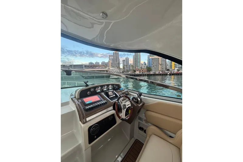  Yacht Photos Pics Interior view of 2018 Crownline 350 SY yacht cockpit with city skyline in background.