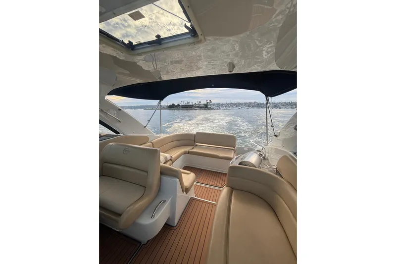  Yacht Photos Pics 2018 Crownline 350 SY yacht interior with beige seating and ocean view.