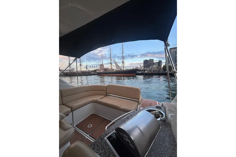  Yacht Photos Pics 2018 Crownline 350 SY boat interior with city skyline and sailing ship in background.