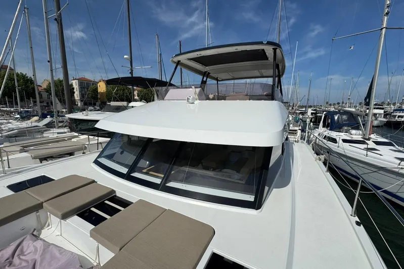 November Xiii Yacht Photos Pics 2019 Fountaine Pajot MY 44 yacht docked in a marina under a clear blue sky.