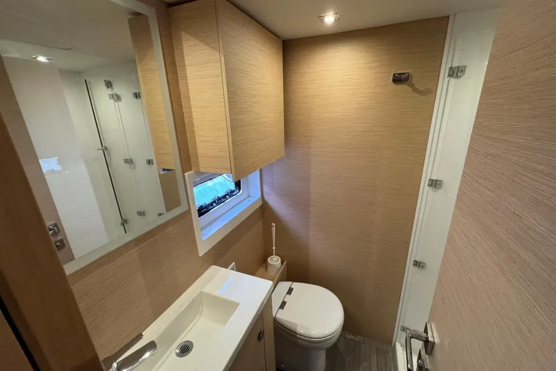 November Xiii Yacht Photos Pics Modern bathroom interior on 2019 Fountaine Pajot MY 44 yacht, featuring sleek design and compact amenities.