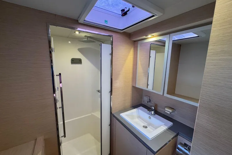 November Xiii Yacht Photos Pics Modern bathroom interior on 2019 Fountaine Pajot MY 44 yacht, featuring shower and sink.